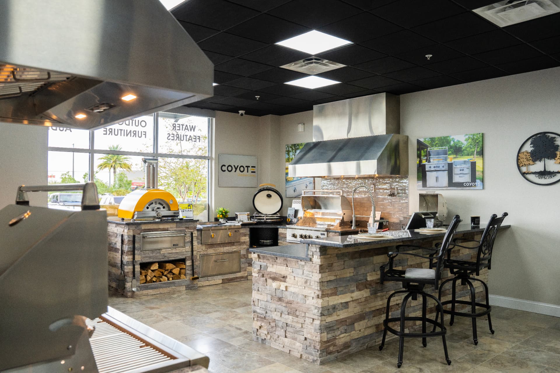 Coyote outdoor kitchen island with bar seating in a Synergy showroom